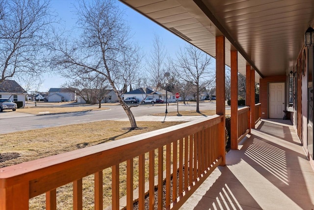 balcony featuring covered porch and a residential view