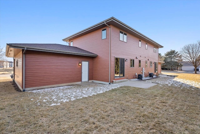 rear view of property featuring a lawn