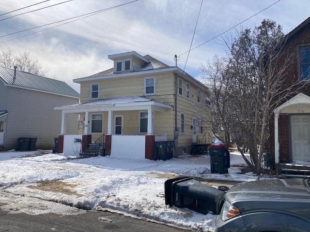 american foursquare style home with covered porch