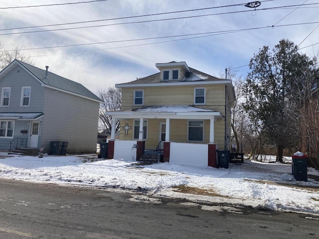 american foursquare style home with a porch