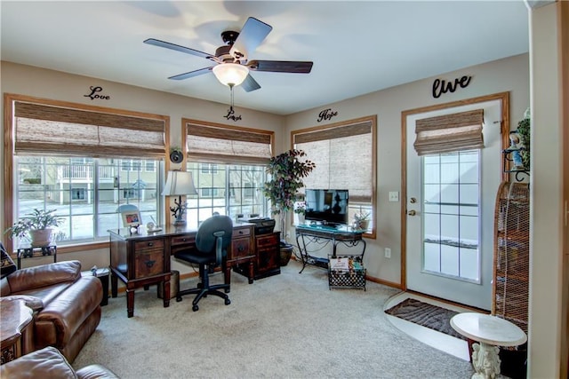 office area with carpet floors, a ceiling fan, and baseboards