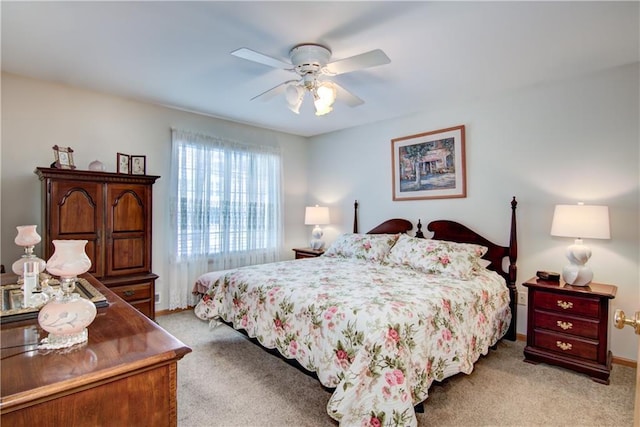 bedroom featuring a ceiling fan, light colored carpet, and baseboards