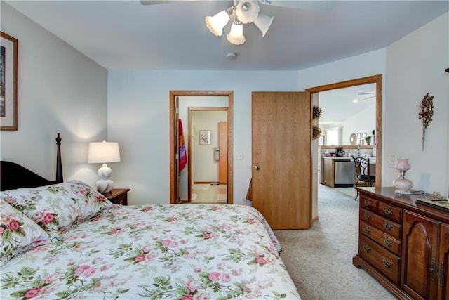 bedroom with connected bathroom, light colored carpet, and ceiling fan