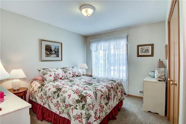 carpeted bedroom featuring baseboards