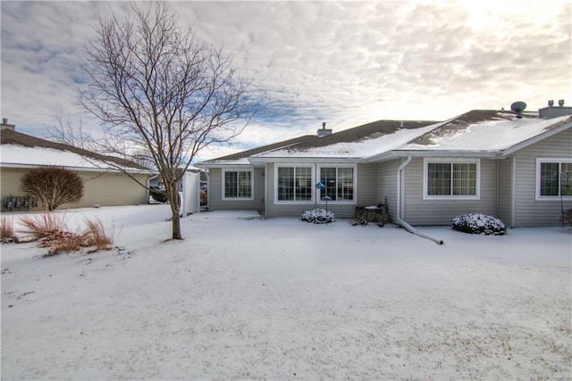 view of snow covered back of property