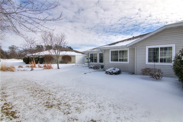 view of snow covered rear of property