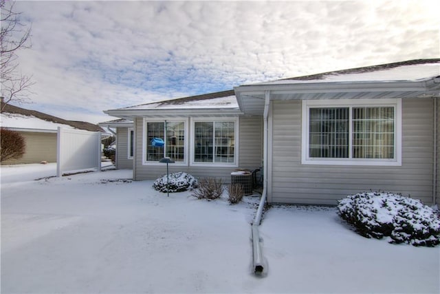 exterior space with cooling unit and fence