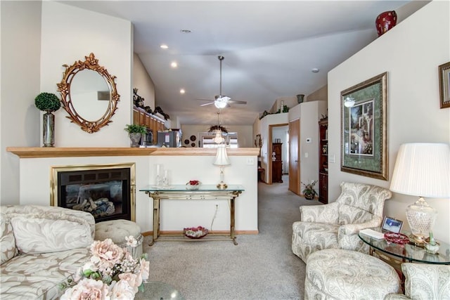 living room with a ceiling fan, a glass covered fireplace, lofted ceiling, carpet, and recessed lighting