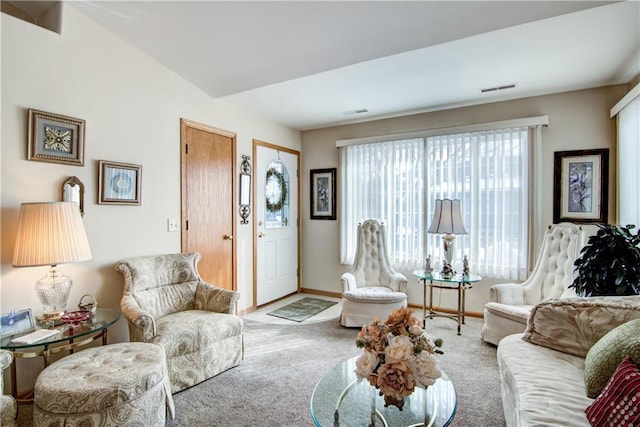 living area featuring baseboards, visible vents, and carpet flooring