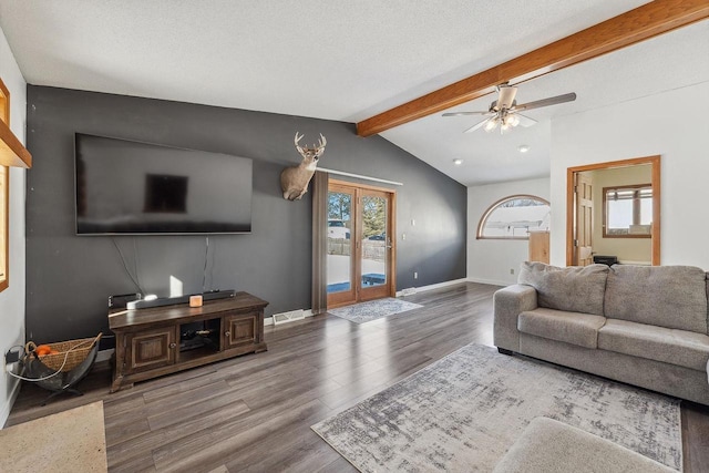 living area with vaulted ceiling with beams, plenty of natural light, baseboards, and wood finished floors