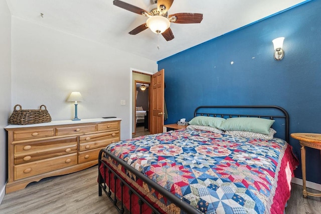 bedroom with ceiling fan and wood finished floors