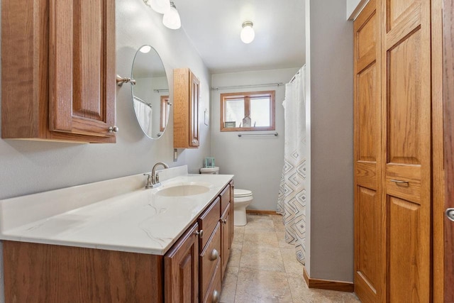 full bath with toilet, tile patterned floors, baseboards, and vanity