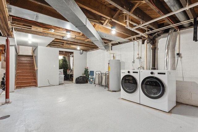 below grade area featuring stairway, gas water heater, and washing machine and clothes dryer