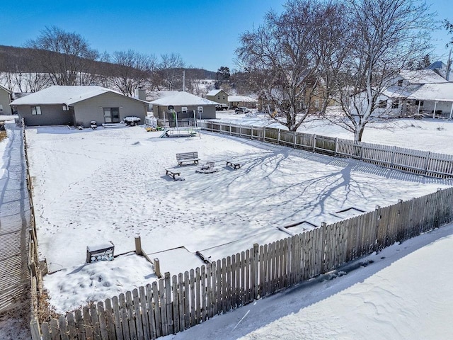 yard layered in snow featuring a fenced backyard