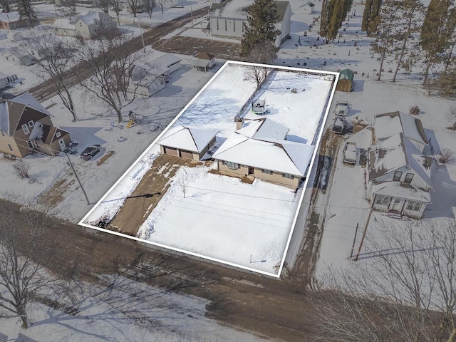 snowy aerial view featuring a residential view