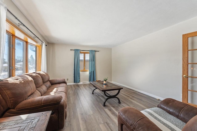 living room featuring baseboards and wood finished floors