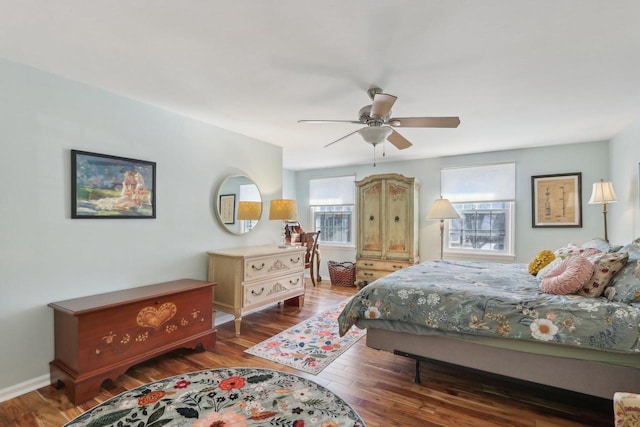 bedroom featuring ceiling fan, wood finished floors, and baseboards