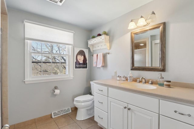 full bath featuring toilet, vanity, visible vents, tile patterned floors, and a shower with door