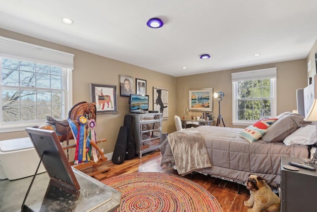 bedroom with baseboards, wood finished floors, and recessed lighting