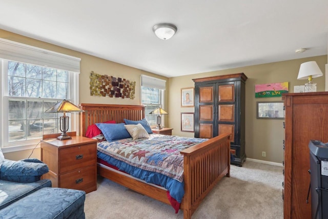 bedroom with light carpet and baseboards