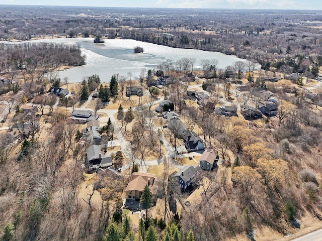 birds eye view of property with a water view and a view of trees