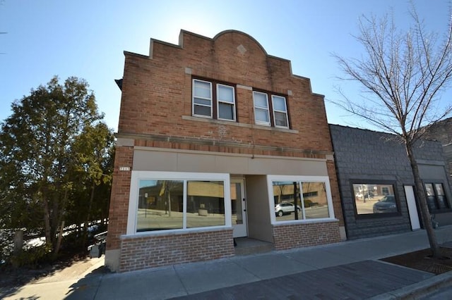 view of front of home featuring brick siding