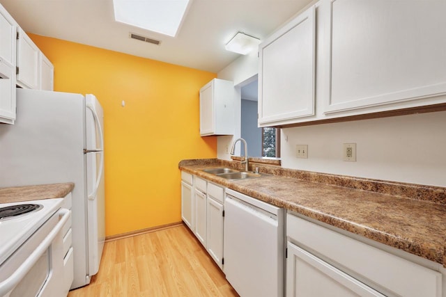 kitchen featuring a sink, light wood finished floors, white cabinets, and dishwasher