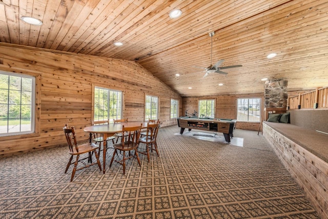 recreation room featuring lofted ceiling, wooden ceiling, a healthy amount of sunlight, and wood walls