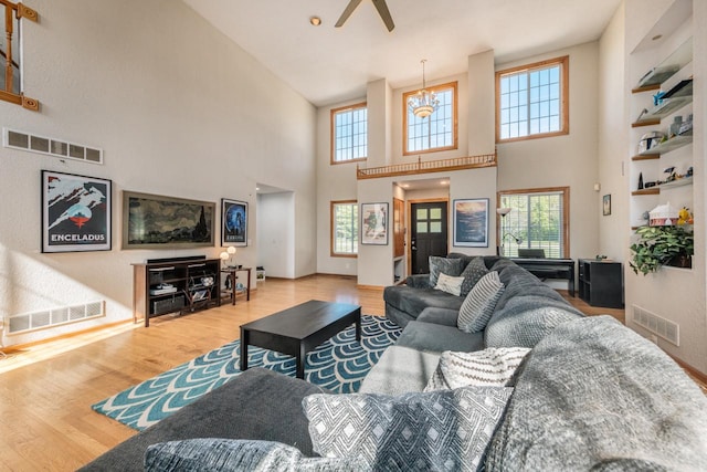 living area featuring visible vents and wood finished floors