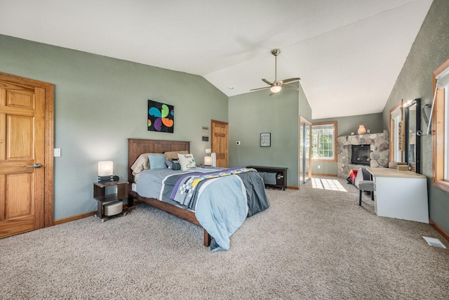 bedroom with carpet, visible vents, a fireplace, and lofted ceiling