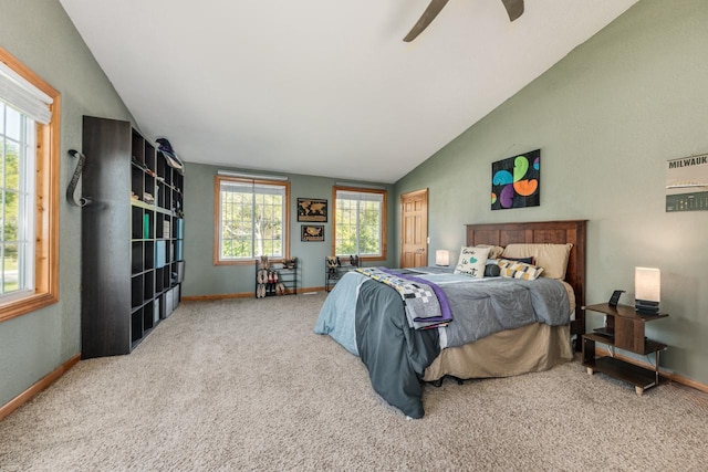 bedroom with carpet floors, vaulted ceiling, and baseboards