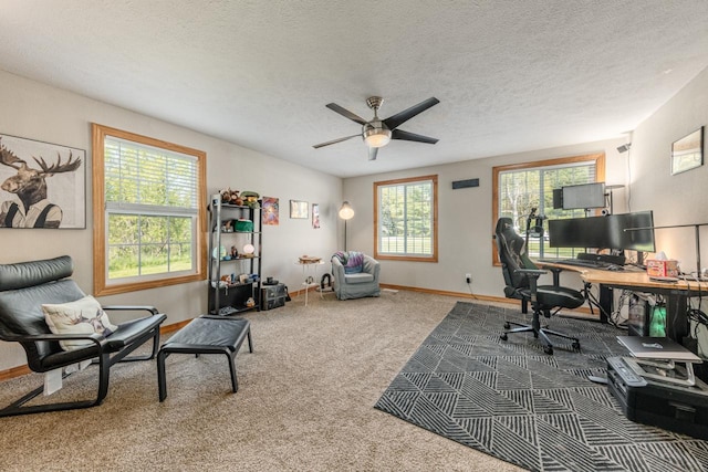 office with carpet floors, ceiling fan, a textured ceiling, and baseboards