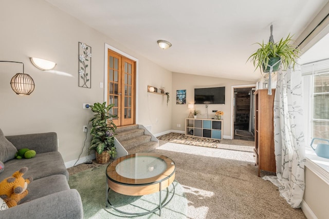 carpeted living area with lofted ceiling, stairs, and baseboards