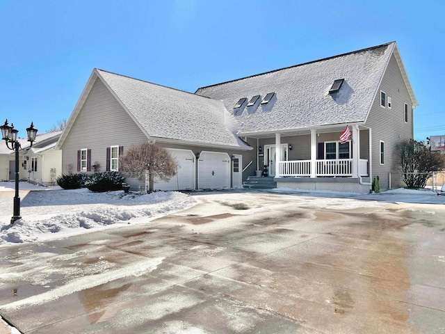 view of front of house with a garage, driveway, a shingled roof, and a porch