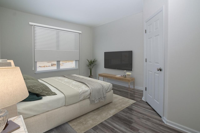 bedroom featuring wood finished floors and baseboards