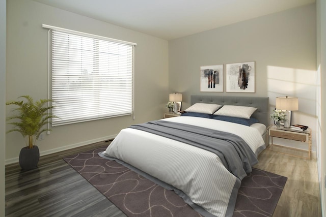 bedroom with wood finished floors and baseboards