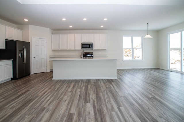 kitchen featuring appliances with stainless steel finishes, recessed lighting, white cabinets, and wood finished floors