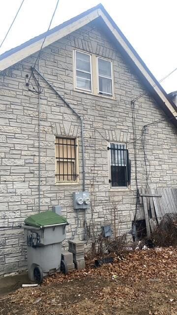 view of side of home featuring stone siding