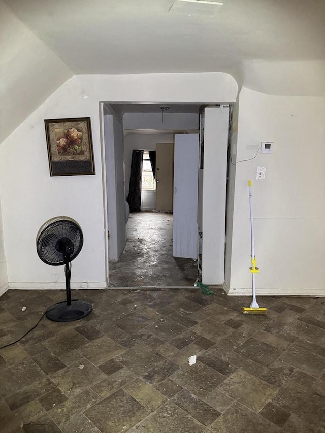 hallway featuring lofted ceiling