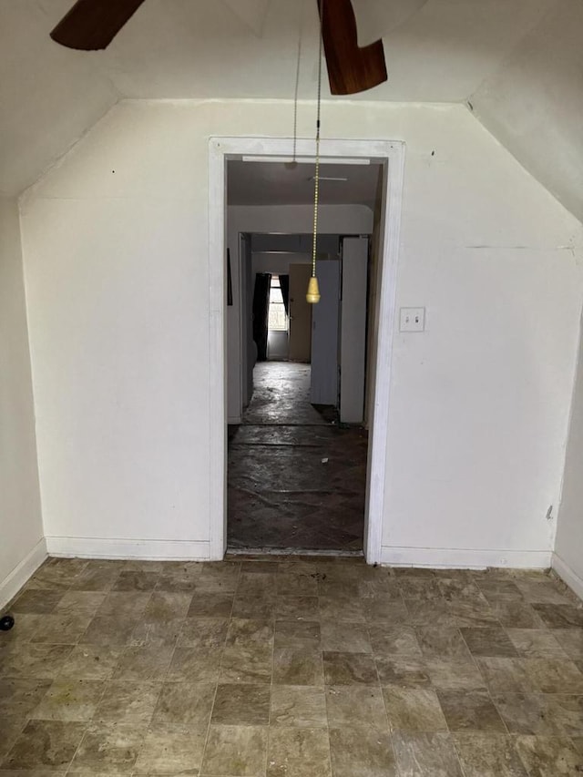 interior space with vaulted ceiling and baseboards