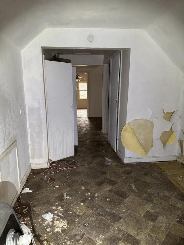 hallway featuring vaulted ceiling