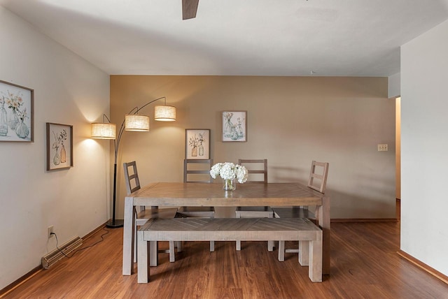 dining area with baseboards and wood finished floors