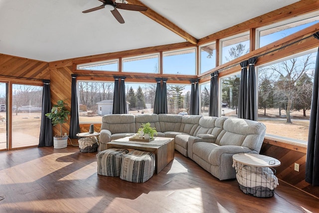 sunroom with lofted ceiling with beams and ceiling fan