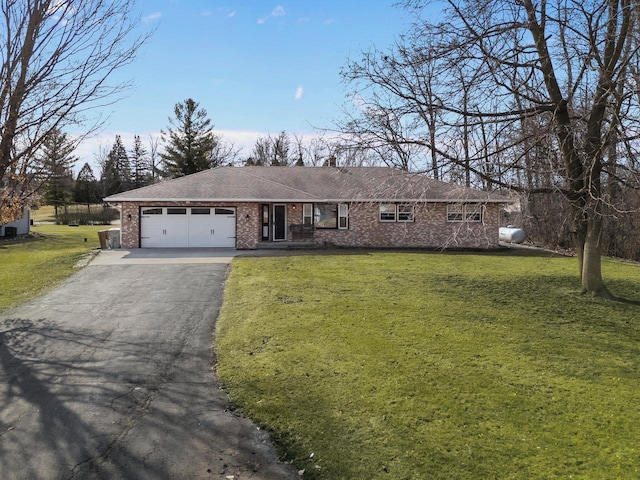 ranch-style house with brick siding, a garage, driveway, and a front lawn