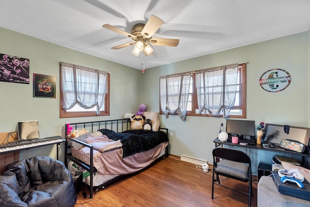 bedroom with baseboards, ceiling fan, and wood finished floors