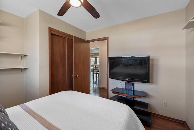 bedroom featuring a closet, a ceiling fan, and dark wood-style flooring