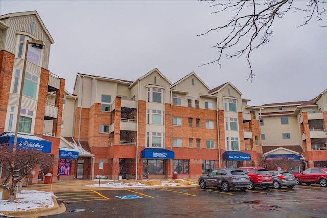 view of building exterior featuring uncovered parking