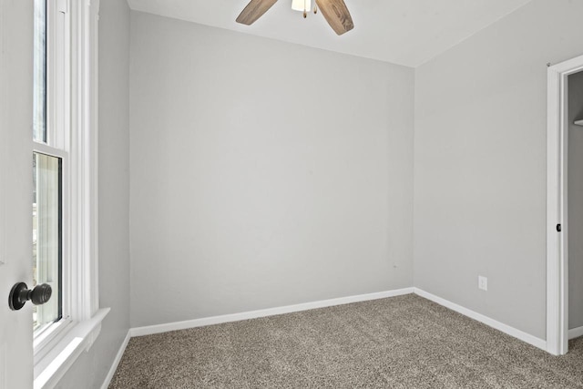 unfurnished room featuring carpet floors, baseboards, and a ceiling fan