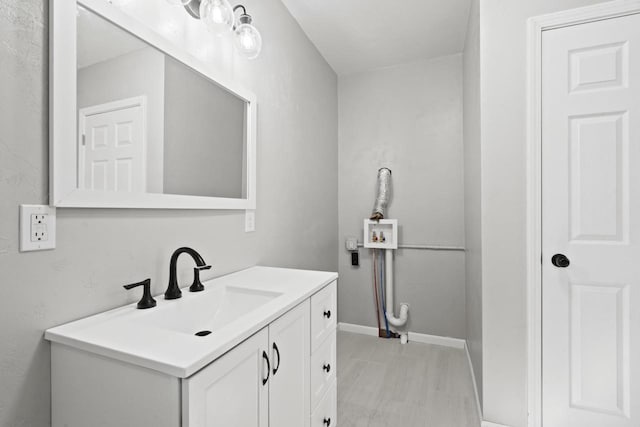 bathroom with vanity and baseboards