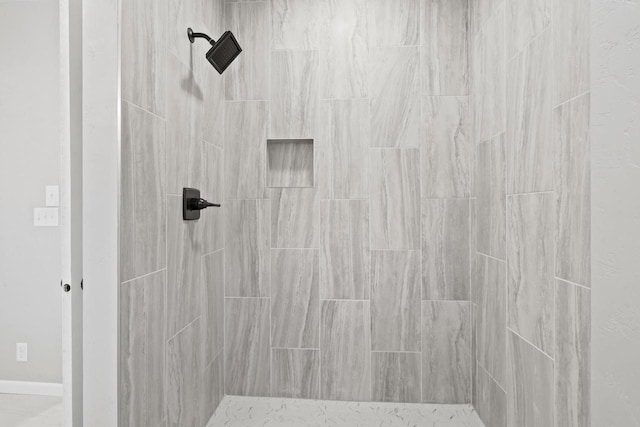 full bath with a tile shower